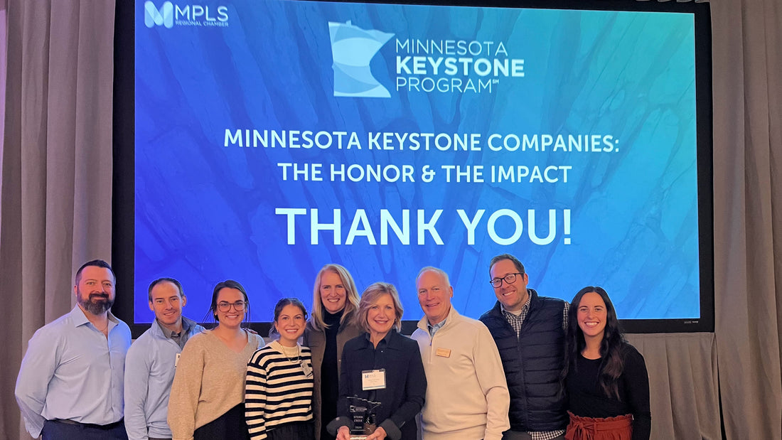 Group of people posing in front of a screen displaying 'Minnesota Keystone Program' with a thank you message.